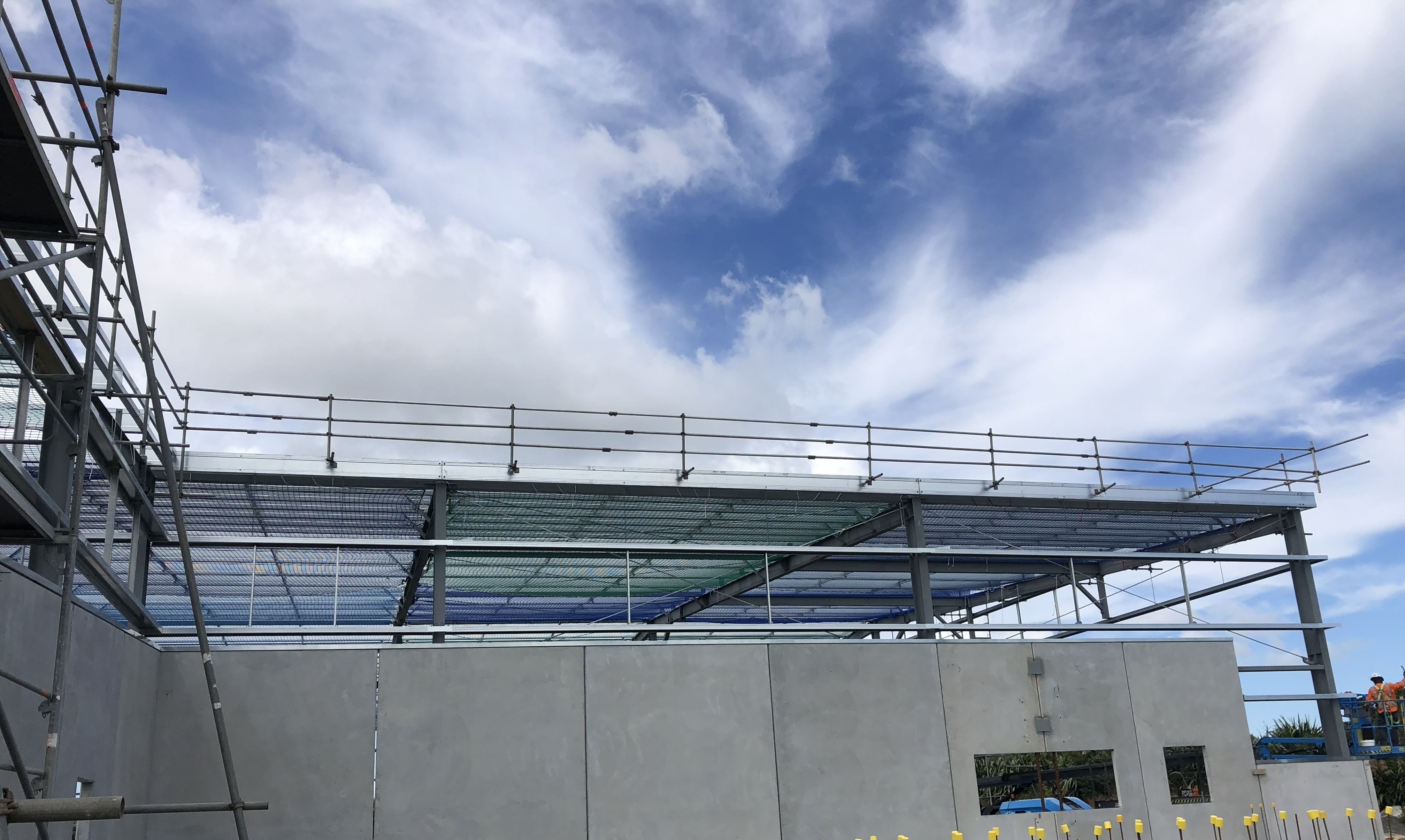 Edge protection and safety netting installed on a building frame